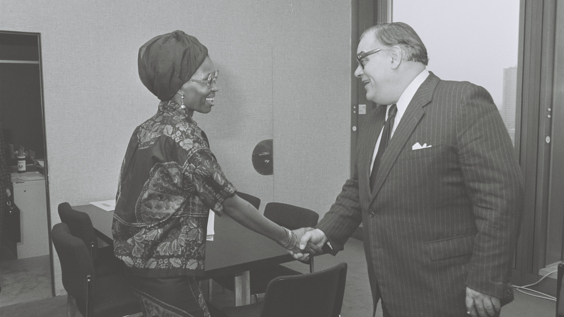 Zala L. N'Kanza at left, shakes hands with Ivor Richard