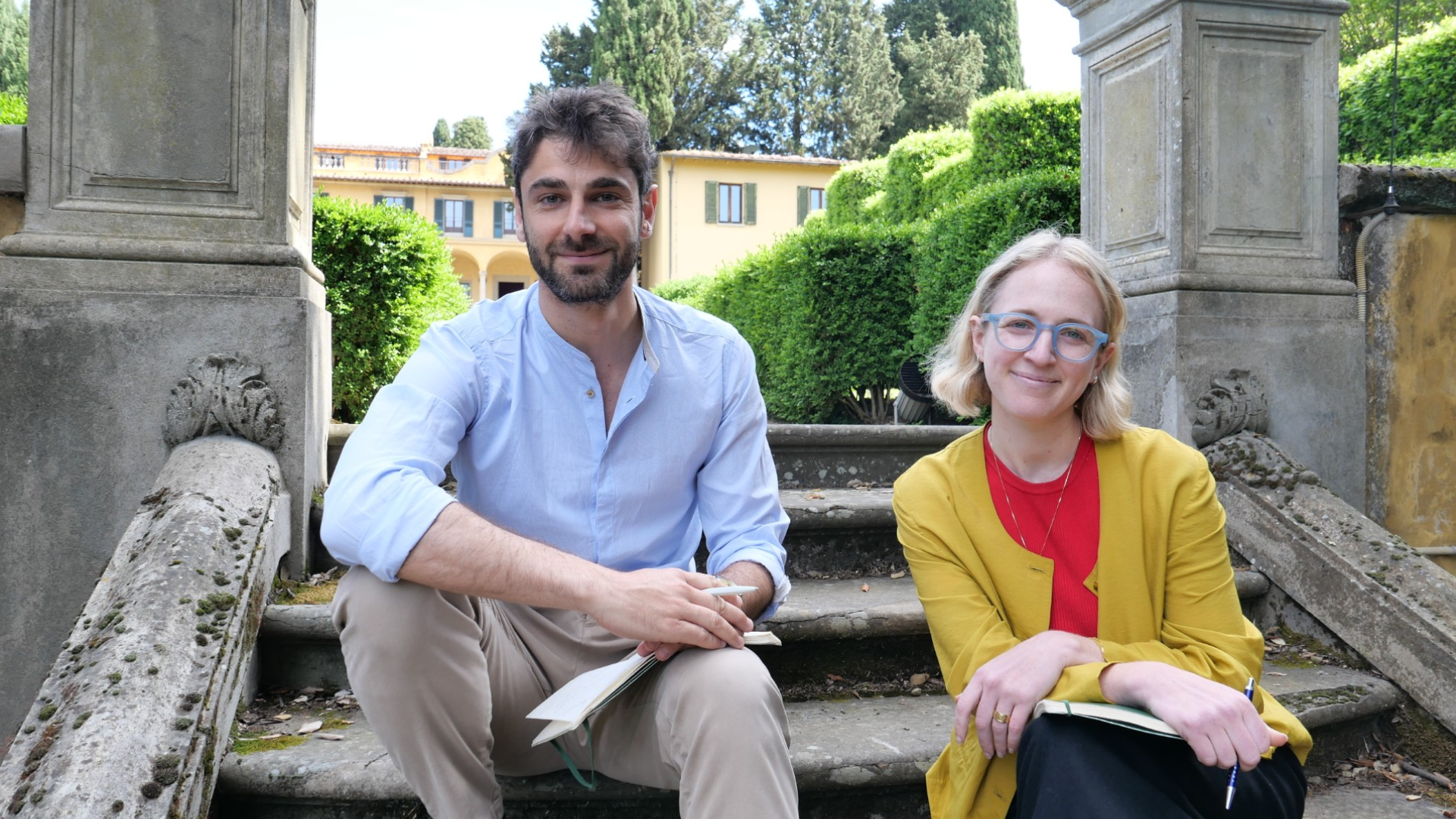 Lorenzo Piccoli and Ashley Mantha-Hollands sitting on the stairs of Villa Schifanoia