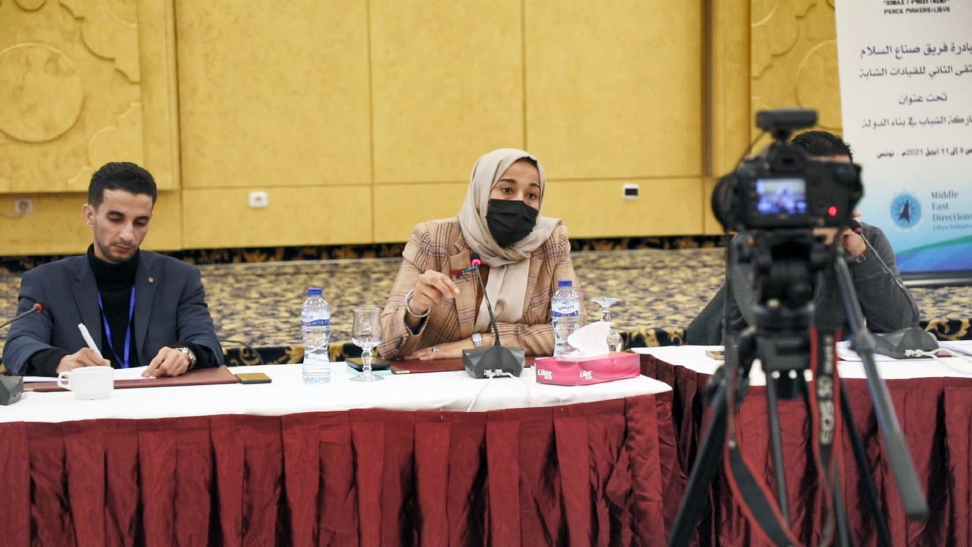 MED Conference with three speakers sitting at a table