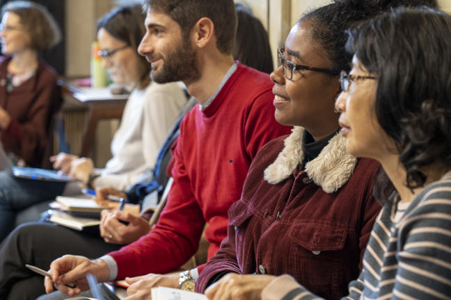 Researchers smiling and attending a seminar