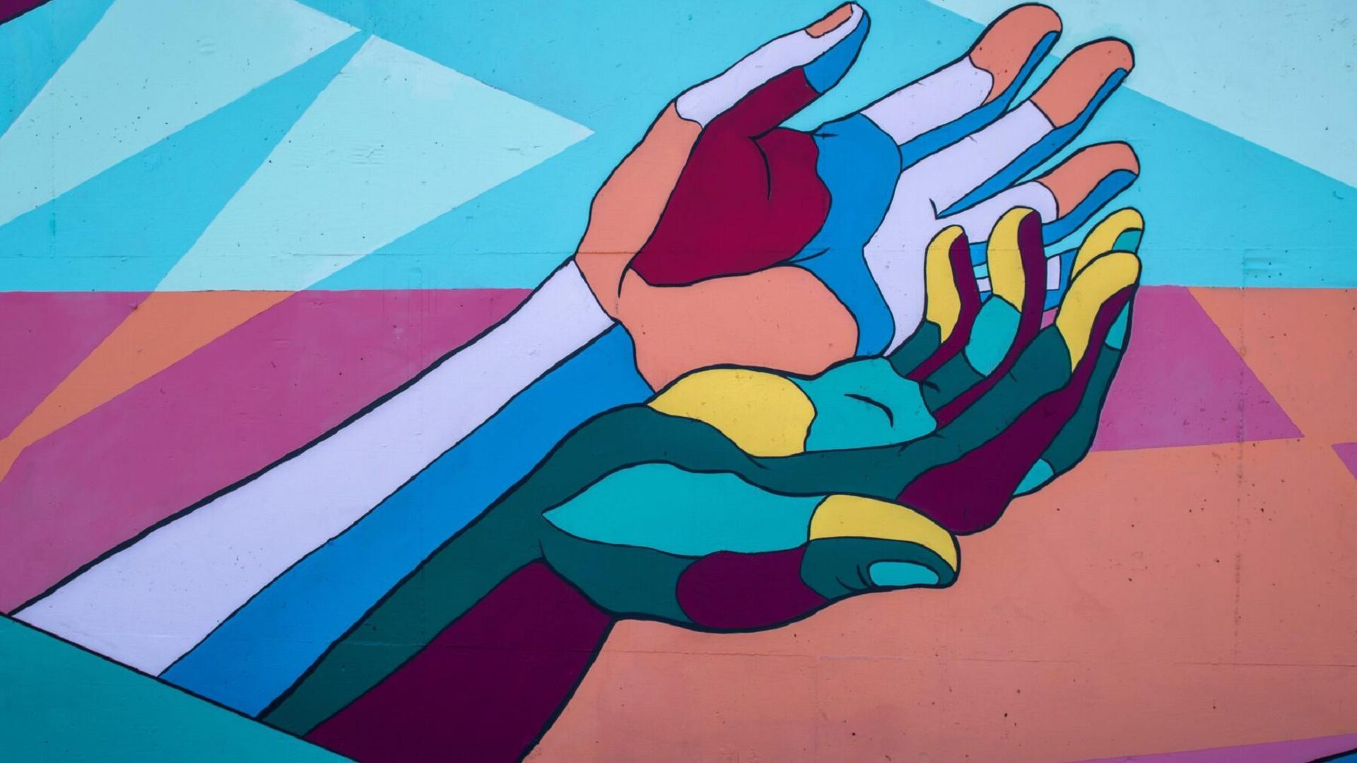 YouGov Conference visual of two colorful hands representing solidarity