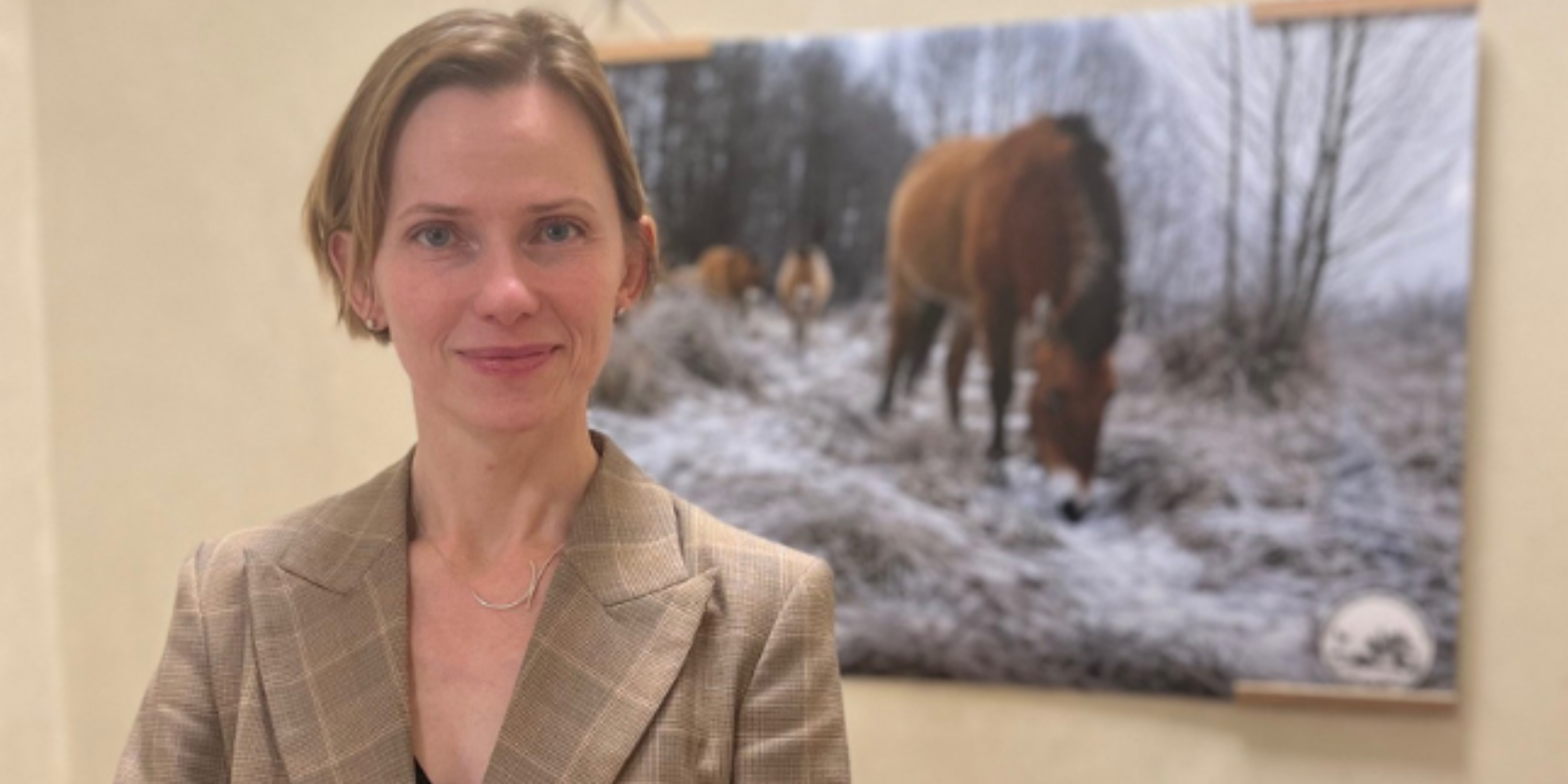 Olena Snigyr in front of a photograph from the exhibition.