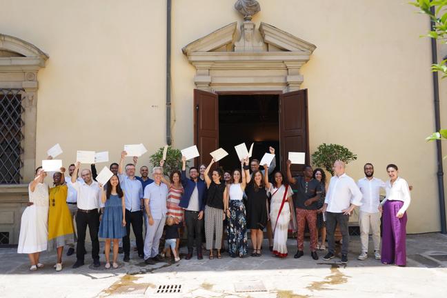 Group photo of STG fellows holding their diplomas