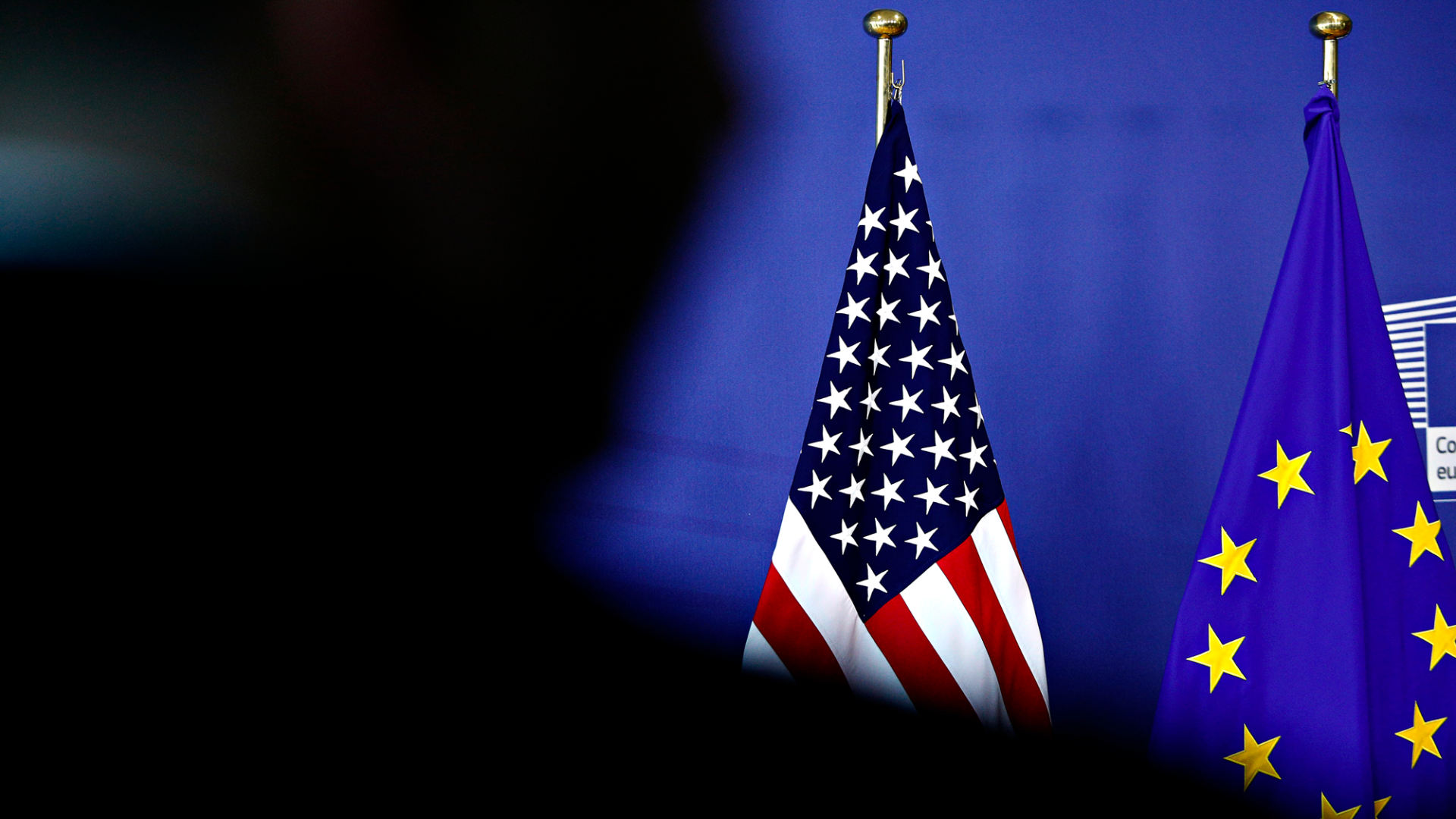 USA and EU flags on a blue background for the news piece on Erik Jone's op-ed for Foreign Affairs 