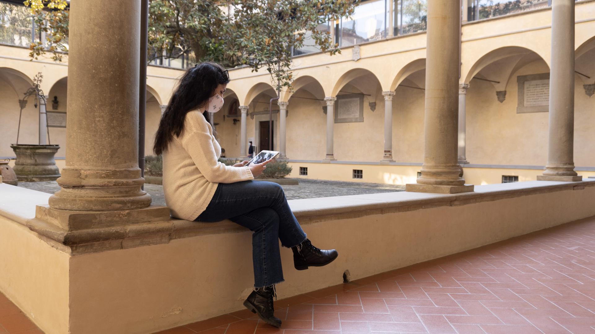 Woman reading in the cloister