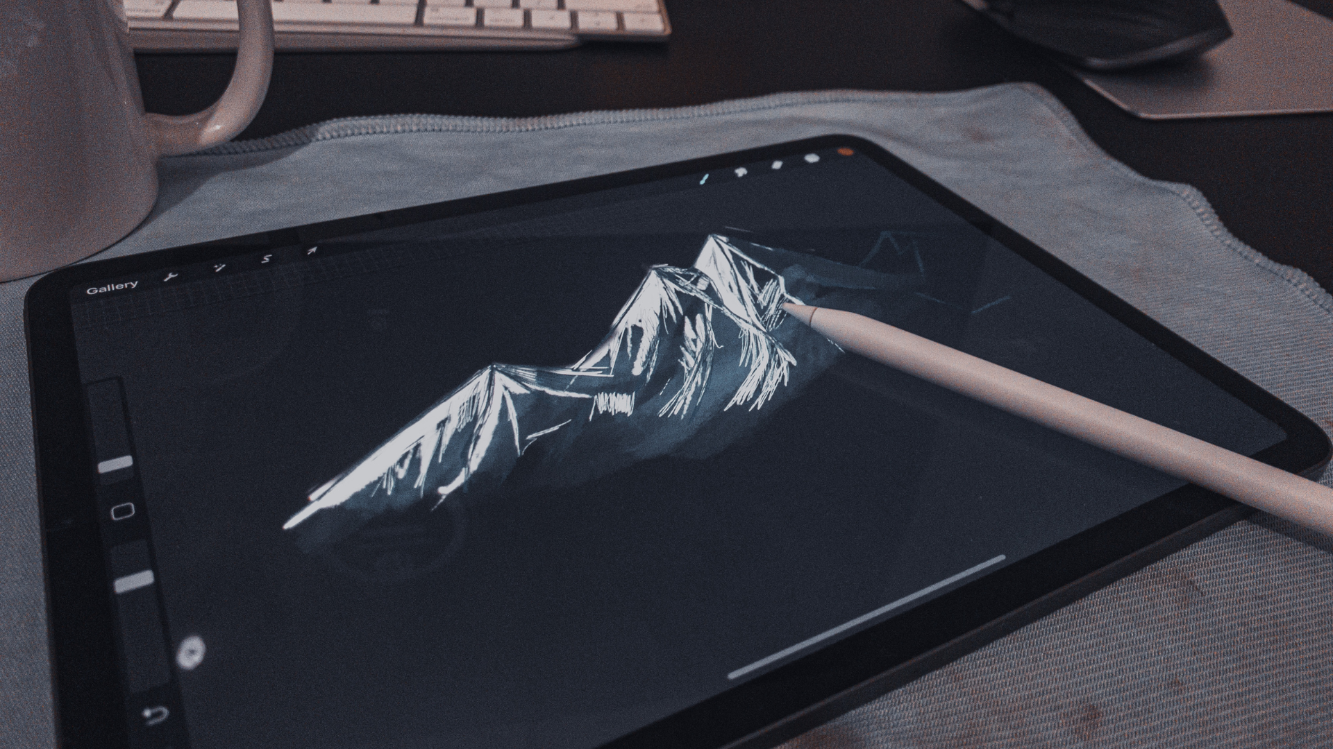 A tablet containing a mountain illustration, with a smart pen over it
