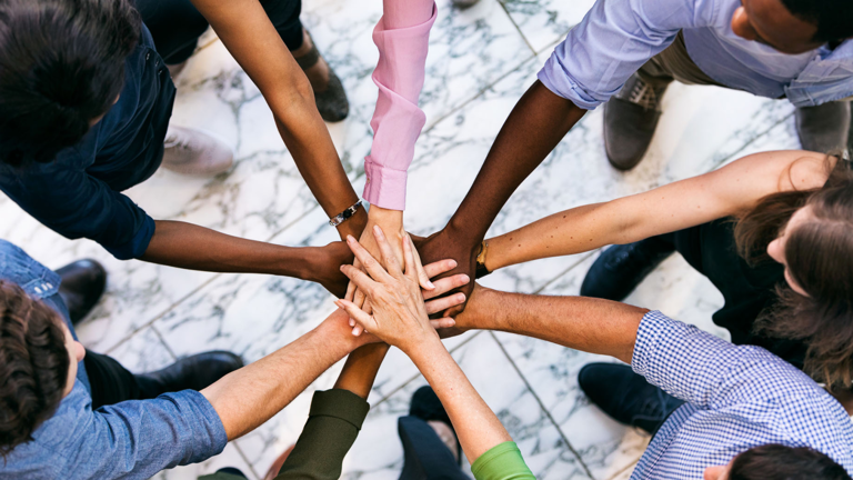 Top view of multiethnic people in circle with joined hands