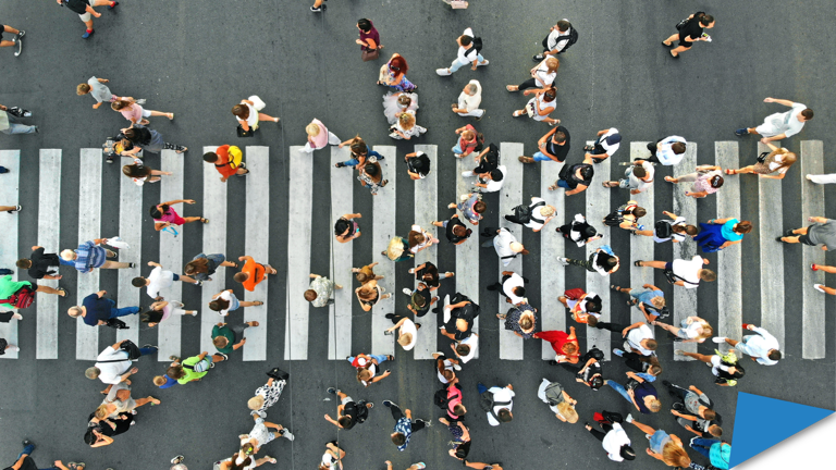 People crossing at a busy street intersection.