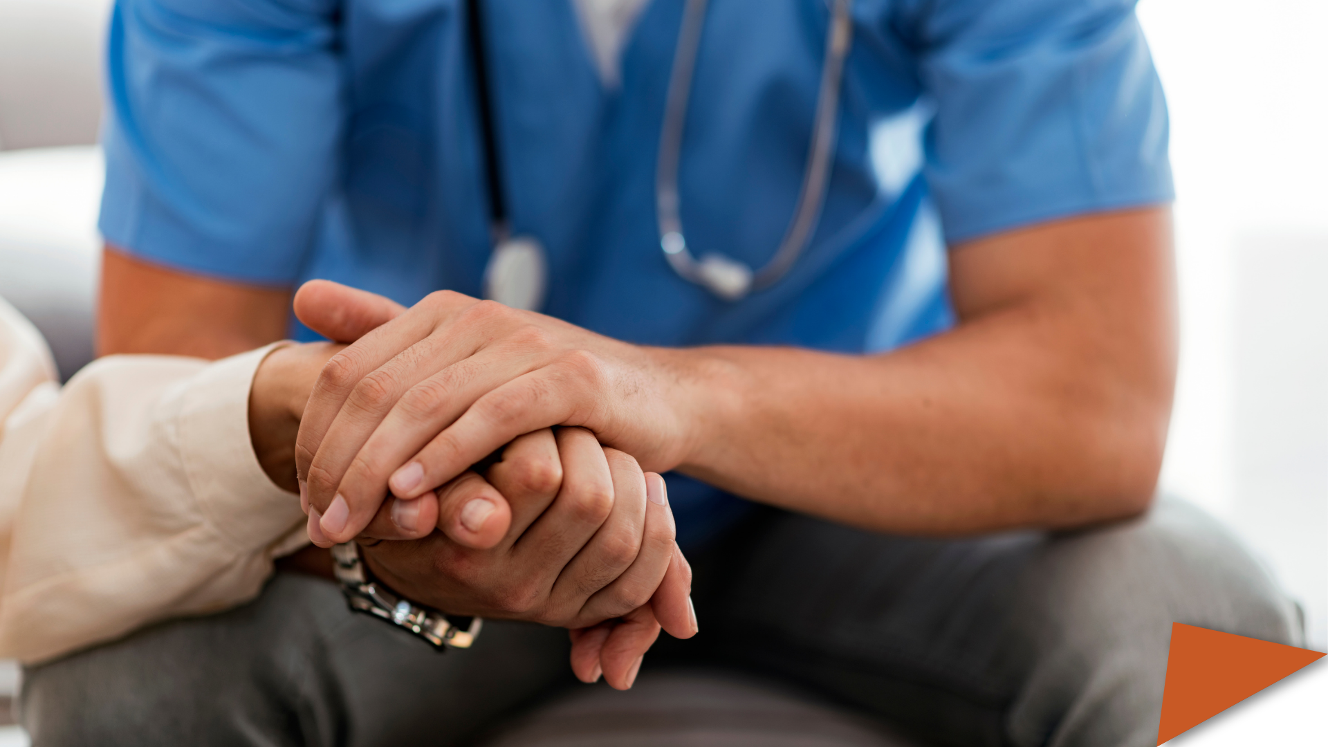 Nurse holding patient's hands.