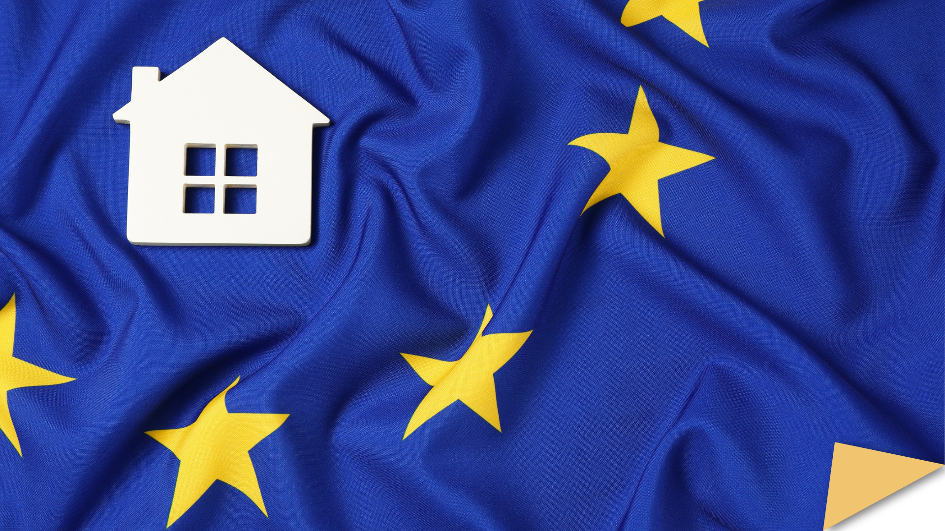Top view of a house model on the flag of European Union.