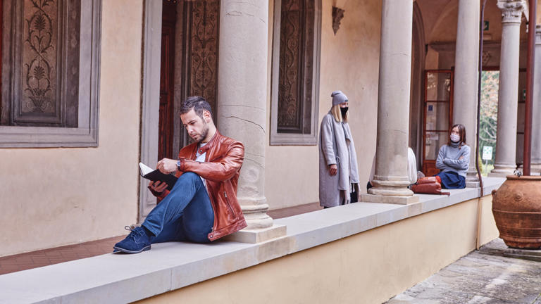 Badia group of people with focus on one student reading a book