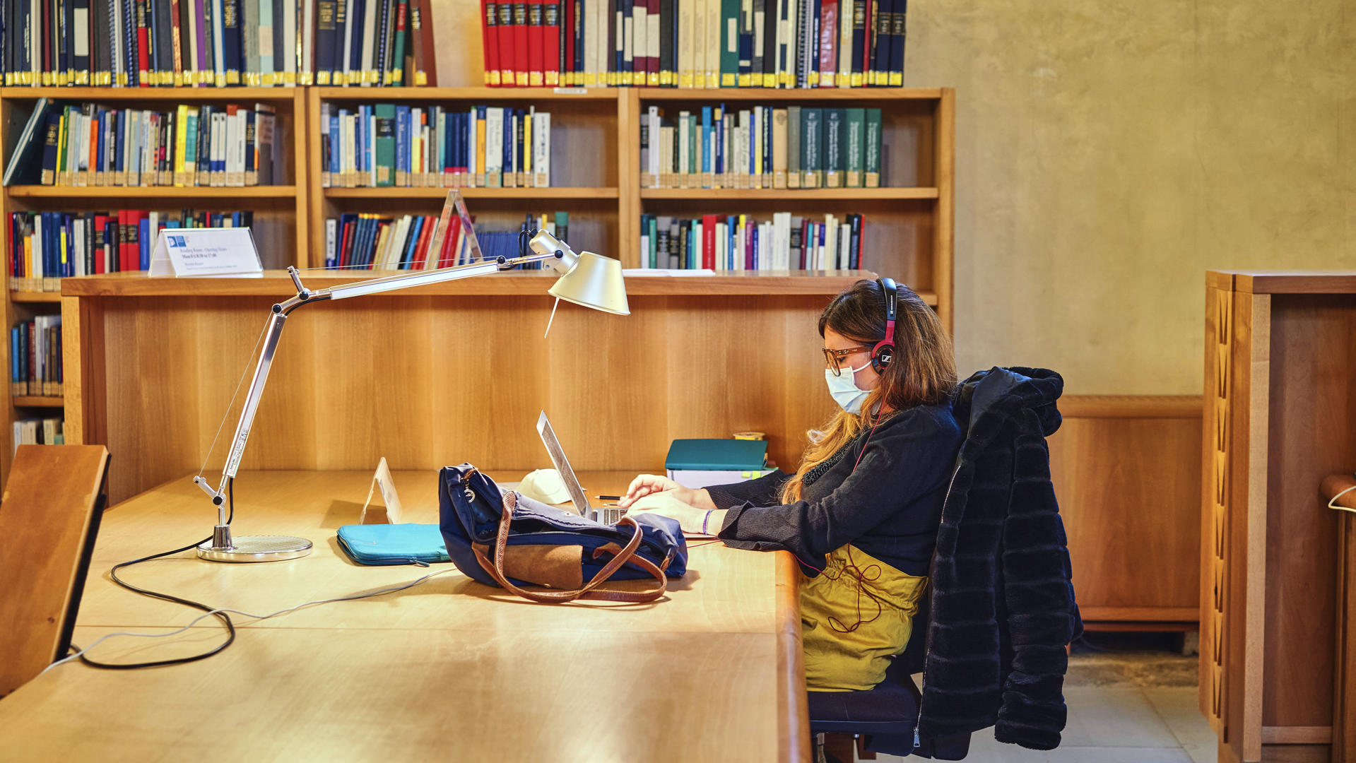 Historical archives researcher studying at desk