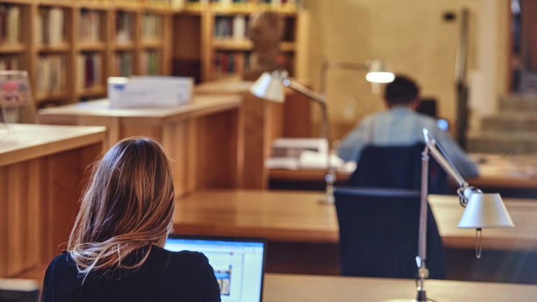 Historical archives study room students with laptops