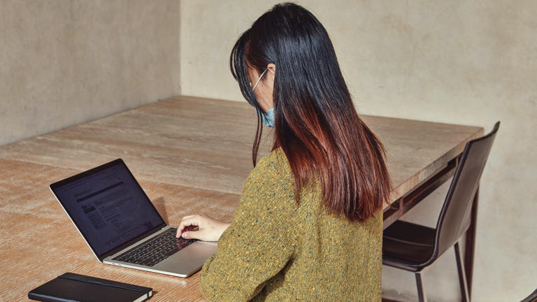 Master student looking up oxford references on laptop