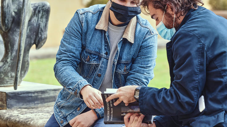Researches looking at a book closeup