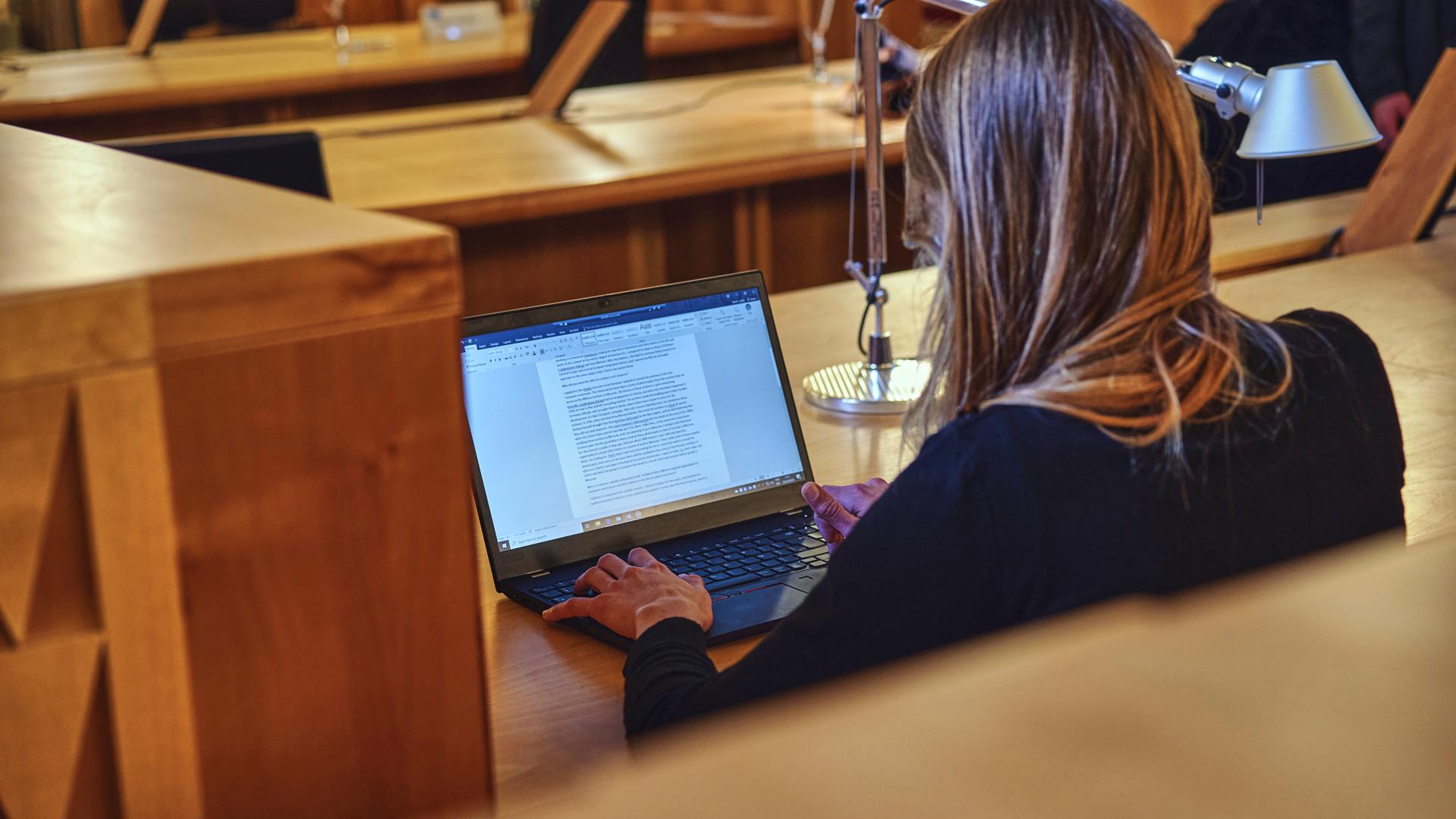 Student studying on her laptop at the historical archives