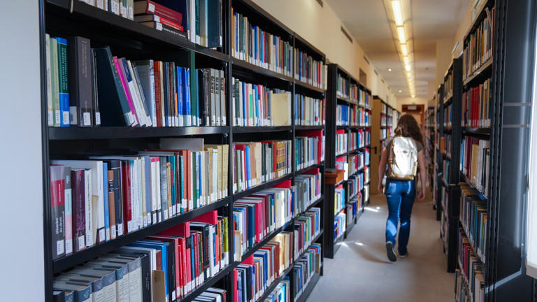 Student walking in the Library hallway
