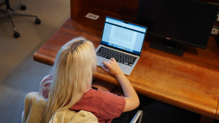 Student working on laptop in the Library