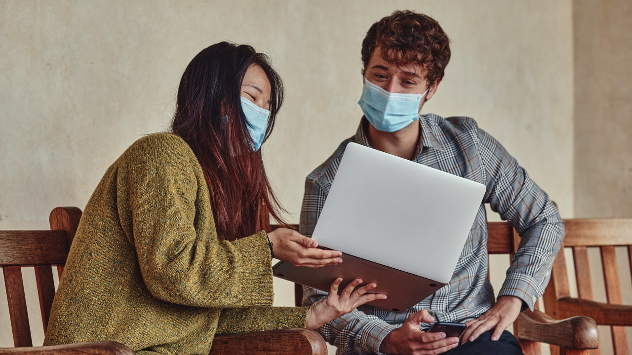 Students looking at laptop together