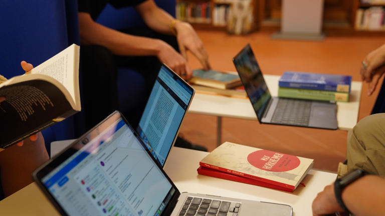 Students on reading chairs at the Library