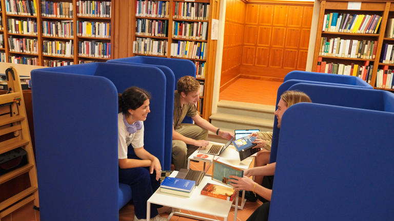 Students on reading chairs at the Library